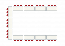 Tables with chairs arranged in a U, open at side of room with video setup.